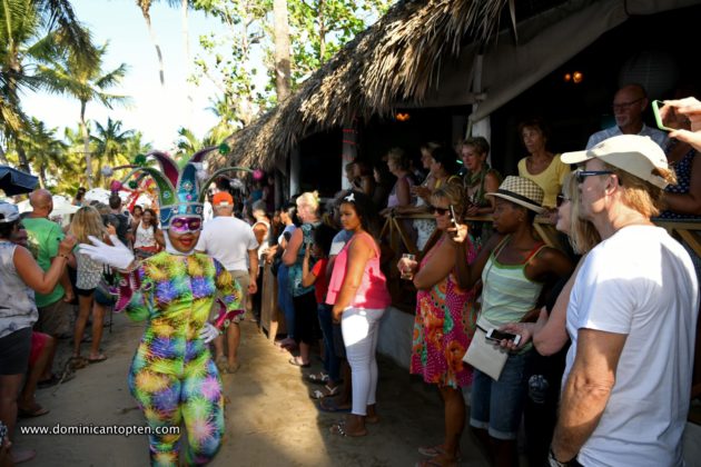 tourists take photos in the 2019 Cabarete beach carnival