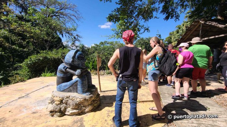 Visitors admiring the Taino statue
