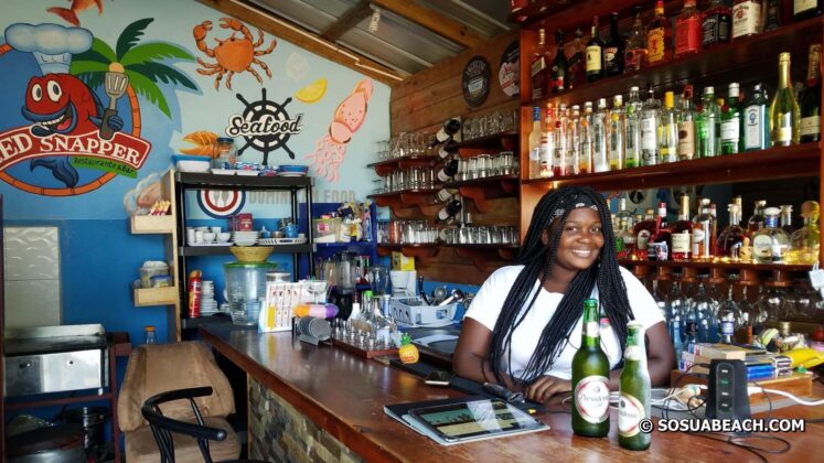 A Haitian bartender in a beach bar