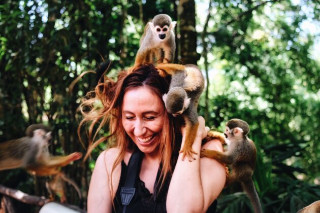 Woman with playful monkeys