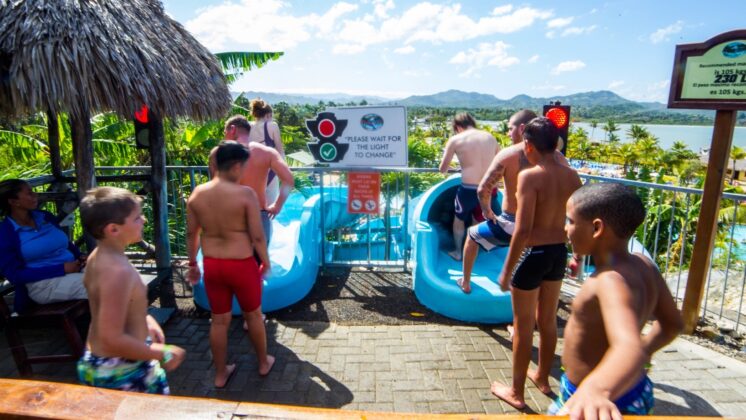 Kids await to use the pool slide